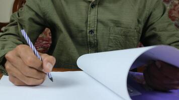 Businessman manager hands holding blue pen for reading and signing in paperwork documentation files photo