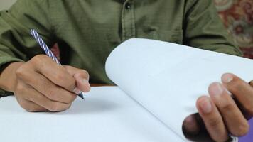 Businessman manager hands holding blue pen for reading and signing in paperwork documentation files photo