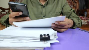 Businessman Preparing reports papers. Piles of unfinished document achieves with paper clip. photo