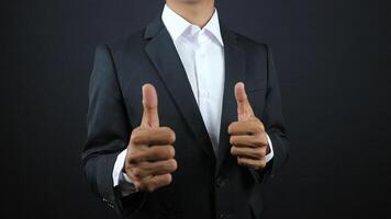 Businessman thumb up on black background photo