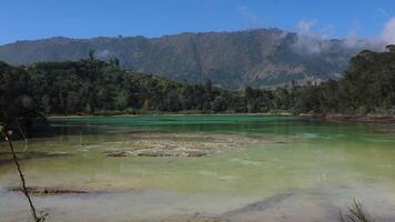 Volcanic lake Telaga Warna at plateau Dieng photo