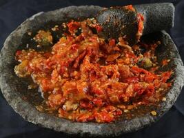 Indonesian traditional chili sauce named sambal terasi or sambal ulek crushed on mortar photo