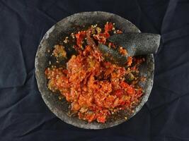 Indonesian traditional chili sauce named sambal terasi or sambal ulek crushed on mortar photo