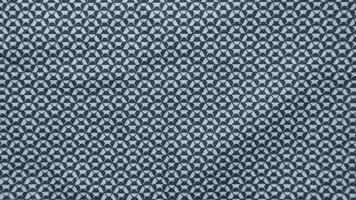 Geometric ethnic pattern made with straw in black and white. knitting fabric pattern for background photo