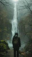 AI generated Man Standing in Front of Waterfall With Backpack photo