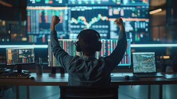 Man Sitting at Desk With Arms Raised photo