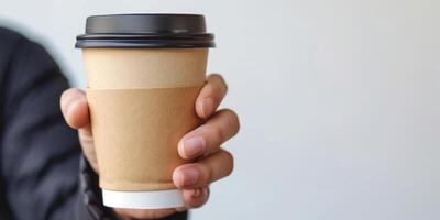 AI generated A persons hand gripping a brown paper coffee cup with a black lid, symbolizing urban lifestyle and eco-friendly choices photo