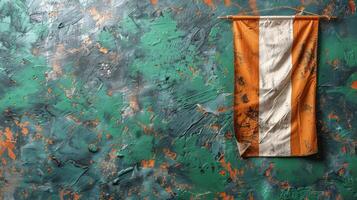 Orange and White Flag Hanging on Green Wall photo