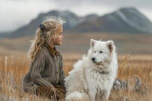 AI generated A young girl sits serenely in a mountain field, accompanied by her loyal white dog, both looking off into the distance. photo