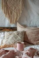 A Bed With a Pink Blanket and a Cup of Coffee photo