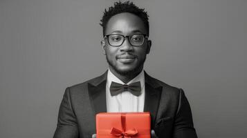 Man in Tuxedo Holding Red Gift Box photo