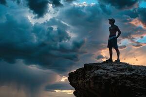 Man Standing on Top of Rock Under Cloudy Sky photo