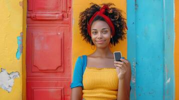 Woman Standing in Front of Colorful Wall Holding Cell Phone photo