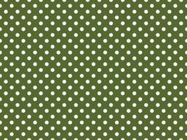 texturised white color polka dots over dark olive green backgrou photo