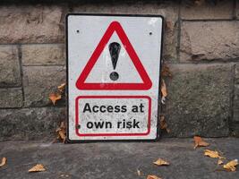 access at own risk sign photo