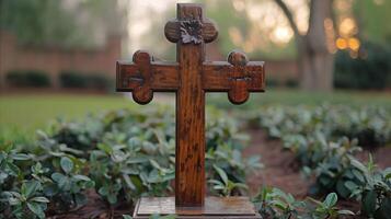 Wooden Cross at Dusk in a Serene Garden Setting photo