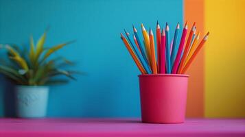 Colorful Pencils in Pink Cup Against Vibrant Background photo
