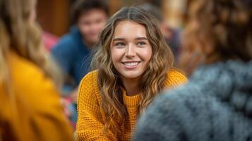 Smiling Young Woman in Yellow Sweater Enjoying Social Gathering Outdoors photo