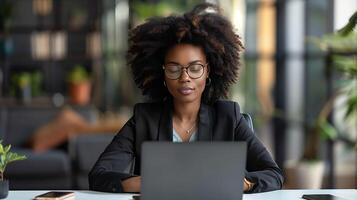 Focused Professional Working on Laptop in Modern Office photo