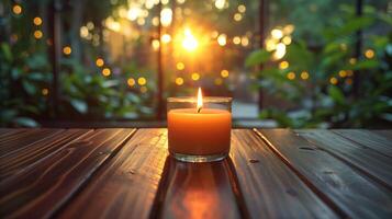 Glowing Candle at Sunset on a Wooden Table photo