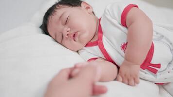 Close-up shot of sweet newborn baby lying in bed. that takes care of happy families and children childhood parenthood video