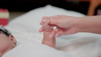 Holding a newborn's hand in slow motion Happy family, mother and her newborn baby together. concept of motherhood video