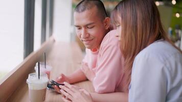 Close-up of a man looking at his lover using a smartphone to surf the internet. video