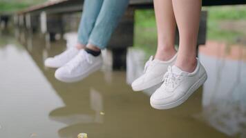 Close-up shot of a couple sitting and chatting and having a date in a green space creates a dreamy atmosphere. video