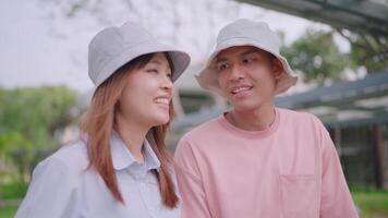 Close-up of young tourists from different nationalities standing and holding hands in a new city. Point at buildings and talk about architecture. video