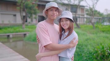 Couple looking at camera and hugging while looking at each other standing at home at dawn video