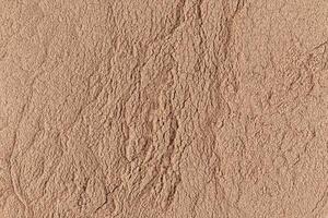 Gorgeous texture of bronze loose powder. Close Up Image. Embossed texture. Cosmetic background. Layout for design. photo