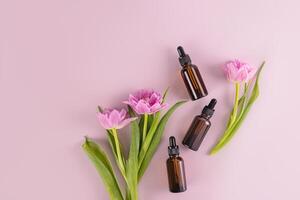 Three dark glass bottles with a dropper with a cosmetic product for daily self-care. Natural cosmetics. Top view. Flat lay. A copy space photo