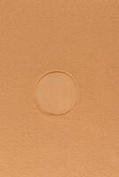 Vertical abstract background of brown or bronze texture cosmetic powder with round imprint from powder block. Layout for design. A copy space. photo