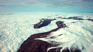 A stunning snow-covered mountain range from above video