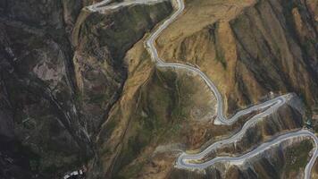 Aerial top down. a winding mountain serpentine descending from a high pass video