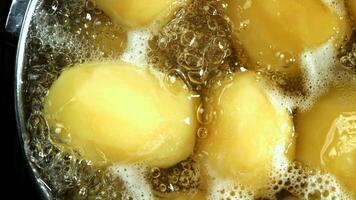 Super slow motion potatoes in boiling wate. High quality FullHD footage video