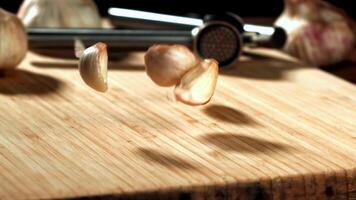 Super slow motion garlic falls on the table. High quality FullHD footage video