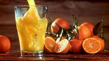 Super slow motion Fresh tangerine juice. High quality FullHD footage video