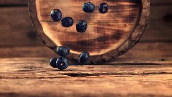 Super slow motion fresh blueberries fall on the table. On a wooden background. Filmed on a high-speed camera at 1000 fps. video
