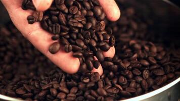 The super slow motion of the coffee beans falls from the man's hand. Macro background.Filmed on a high-speed camera at 1000 fps. video