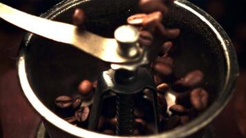 Super slow motion of coffee beans fall into the coffee grinder. High quality FullHD footage video