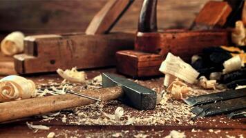 Nails fall on the table with a hammer. On a wooden background.Filmed is slow motion 1000 frames per second. High quality FullHD footage video