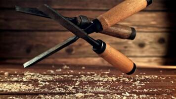 Chisels fall on a wooden table. On a wooden background. Filmed is slow motion 1000 fps. High quality FullHD footage video