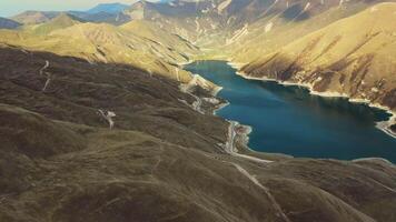 Aerial. alpine lake. Turquoise water contrasts with the spring mountains video