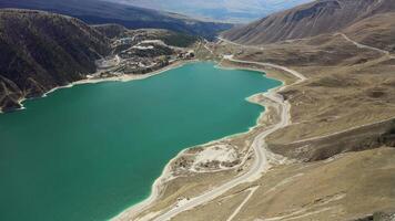 Aerial. turquoise water of the mountain lake Kazenoy-Am in the spring mountains video