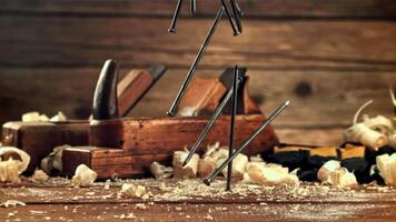 A bunch of nails fall on the table. On a wooden background. Filmed is slow motion 1000 frames per second. video