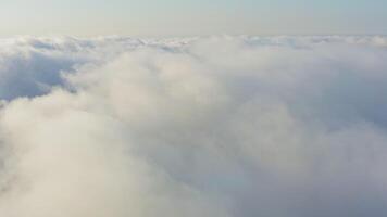 The drone rises from the thick fog over the beautiful ocean of clouds at dawn video