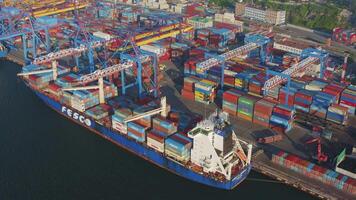 Cargo containers being unloaded by a gantry crane from a container ship video