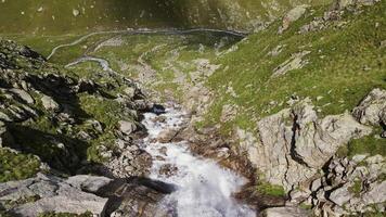 Waterfall in the Bezengi Gorge. Water falling over rocks. aerial view video