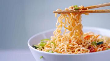 Cooked instant noodles sprinkled with spices, vegetables, herbs. photo